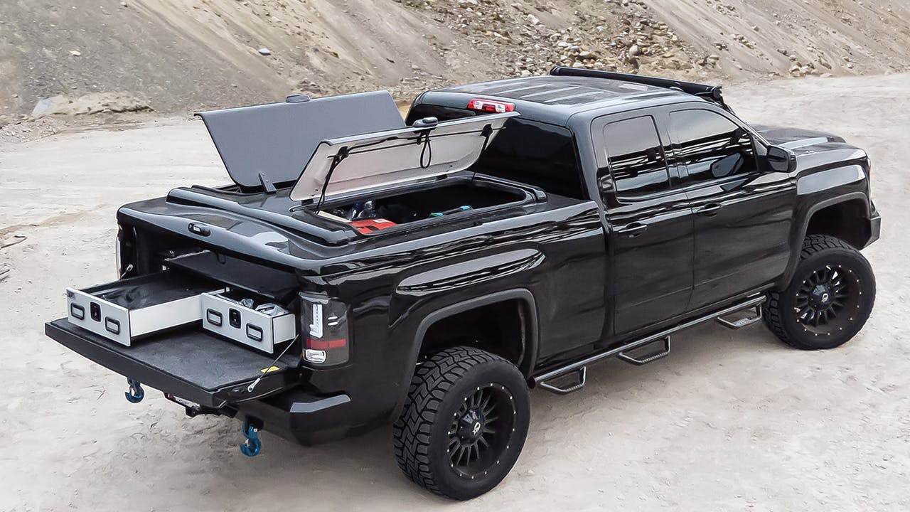 Placeholder image of an A.R.E. Overland style truck cap on an off road build