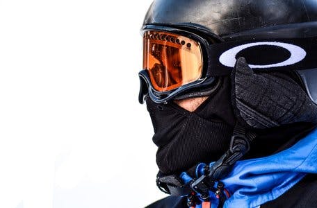 Oakley snowboard goggles with mirrored lenses in the snow
