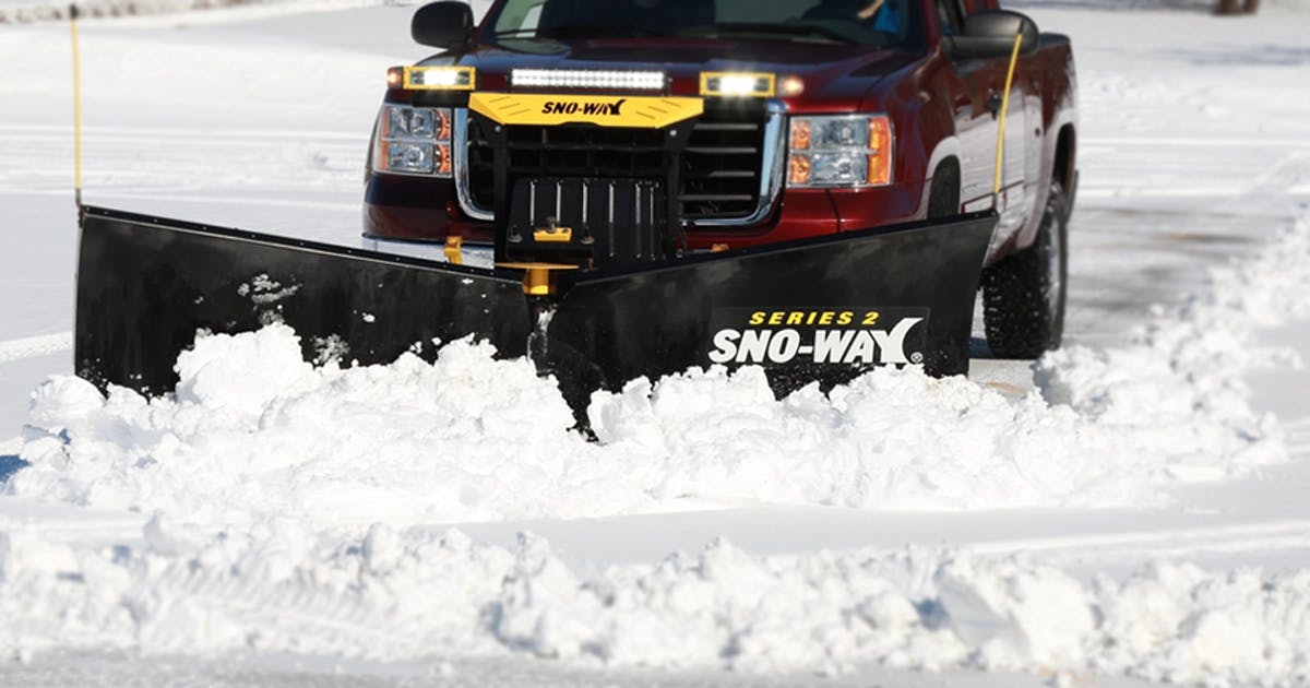 Sno-Way V box spreader applying material on an access road