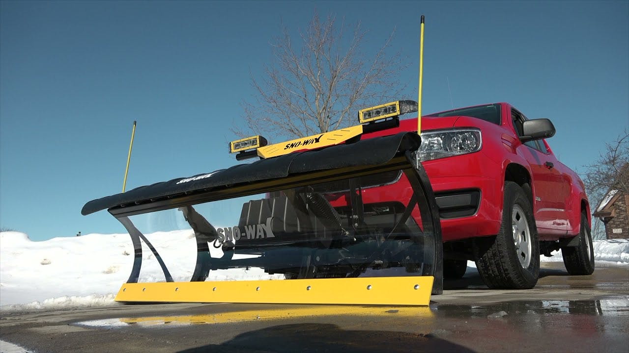 Sno-Way plow working on a commercial parking lot