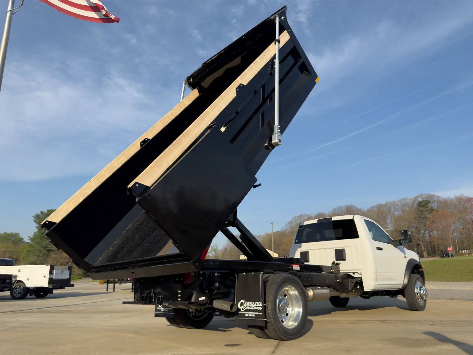 Steel dump bed raised to show dump function and rear access