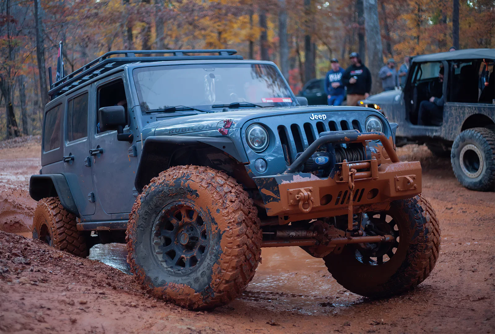 Blue Jeep Rubicon on a muddy trail at Uwharrie 2021