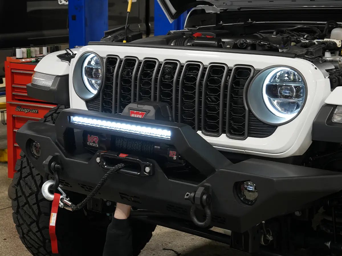 Jeep with WARN winch and front-end accessories at Cape Fear Customs
