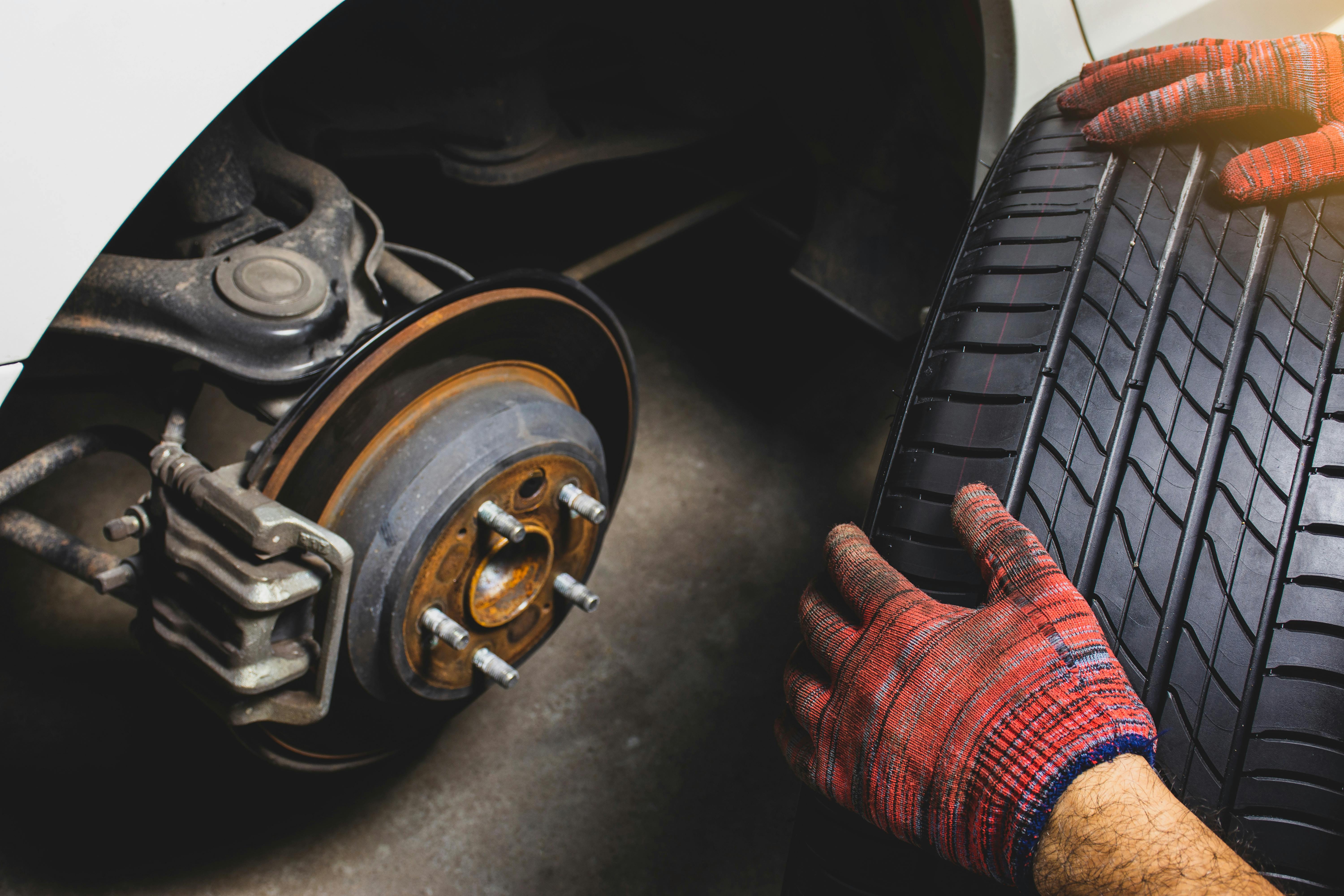 Technician working on vehicle with tools and equipment