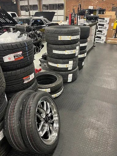 Close up image of a concave multi spoke wheel and high performance tire