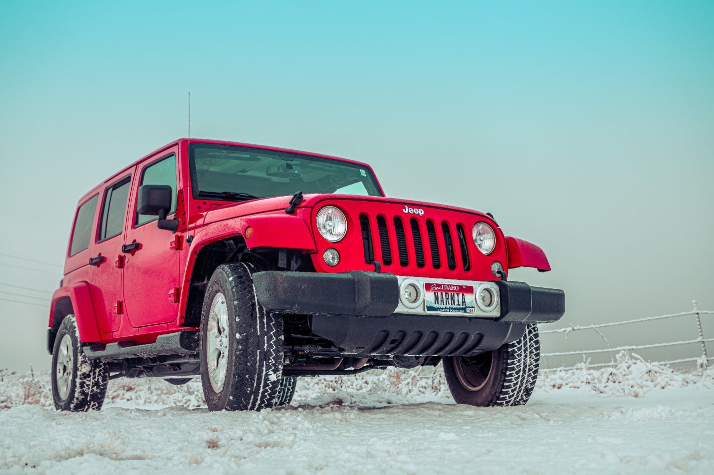 A red truck on a dirt road