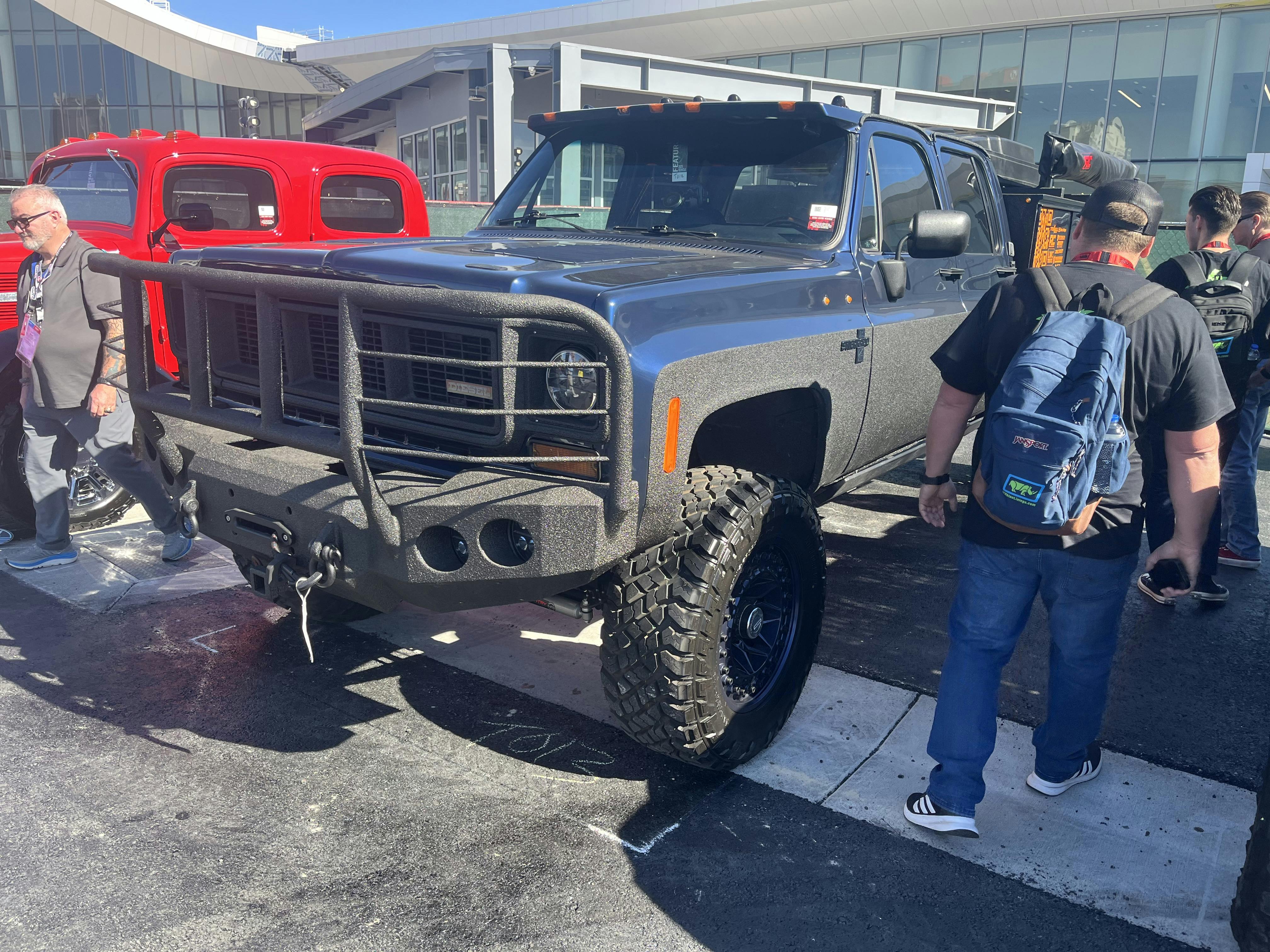 A person standing next to a truckAI-generated content may be incorrect.