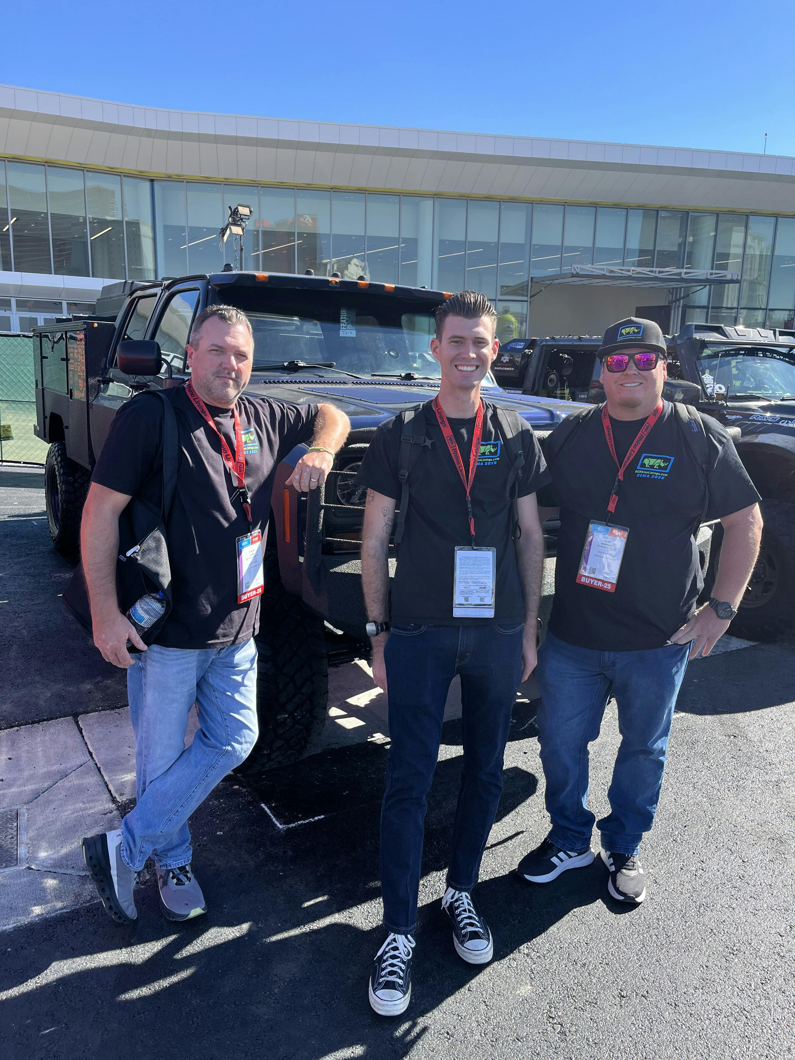 A group of men standing next to a vehicleAI-generated content may be incorrect.